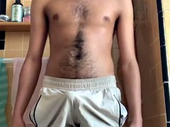 Hairy guy rubs himself, pees in shorts and cums afterwards