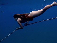 A girl from Tenerife swims naked underwater