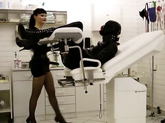 Perverted mistress is playing with tied-up gimp's cock and balls