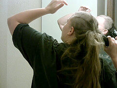 lengthy haired wife shaves her hair in a ponytail