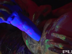 Black-light babes Nadia and Ophelia suck off a colorful cock