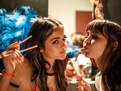 Sexy brunettes girls are scissoring on the theatre floor